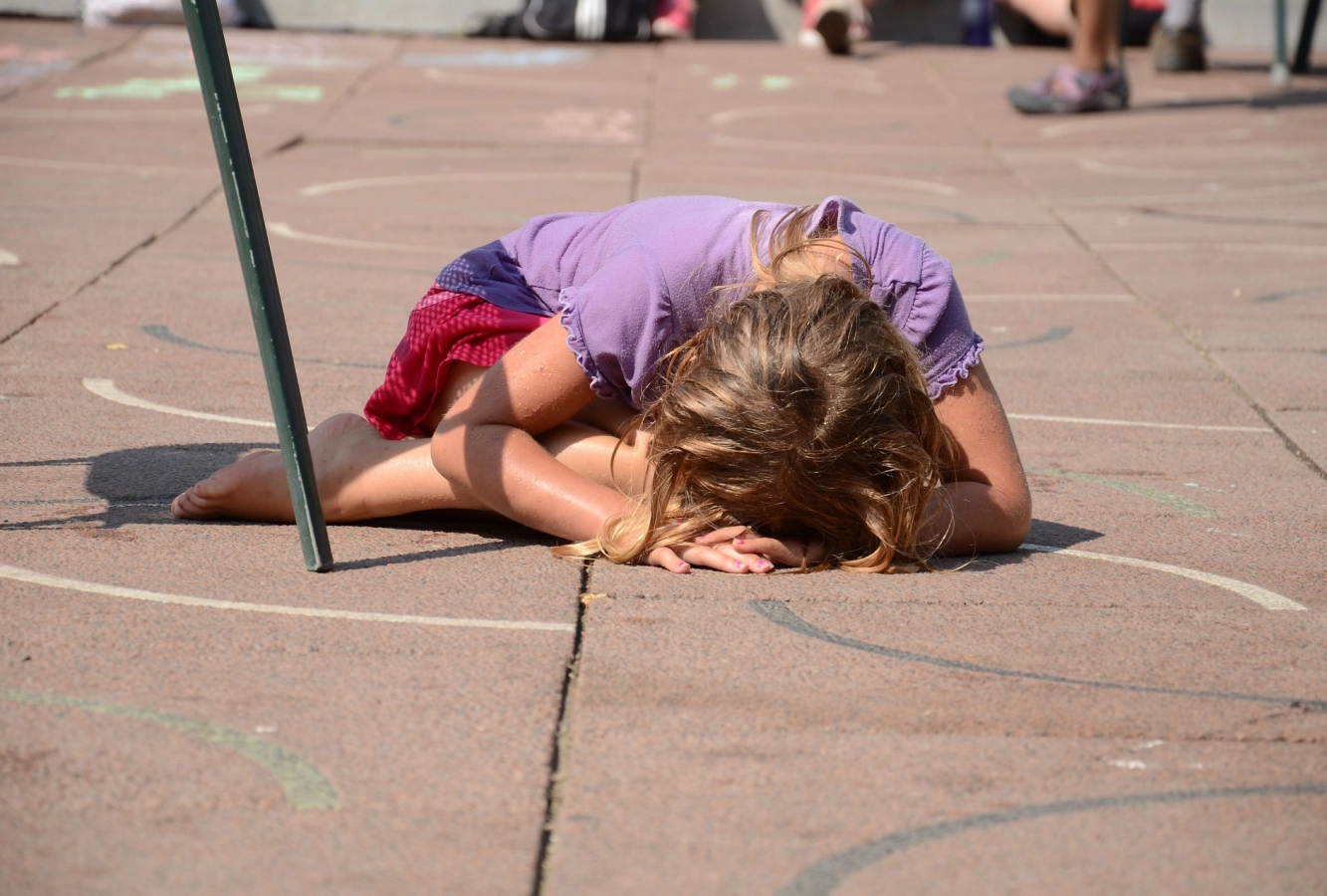 Young girl led on floor crying